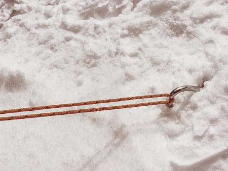 Chrome steel hook anchor camping tent in snow. Process of installing tent setting up tent outdoors.