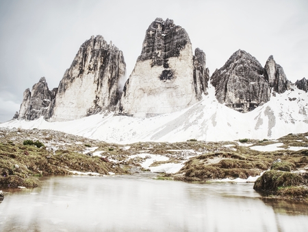 North side of Sexten Dolomites symbol - Tre Cime. May view from popular trail around the rocks. The...