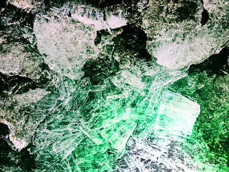 Melting ice tip of the iceberg. The sun shines through ice cracks and create interesting...