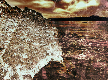 Symbol of harsh winter. The rays of the sun form rainbow shadows in the cracks of the ice .. Hipster...