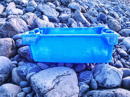 Dangerous garbage ejected from the sea on remote beaches. Environmental contamination with toxic...