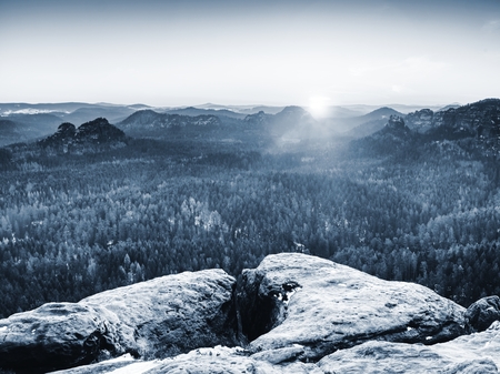 View from rock to far horizon with light rays and lens flare effect.  Real landscape
