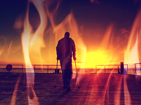 Hurt man on pier in the sunrise. The wharf construction above sea follow  Sun. Hipster filter.の写真素材