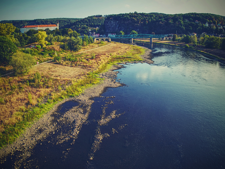 Empty river. Drying out of big river. Horrible smell of poisoned muddy water.の写真素材