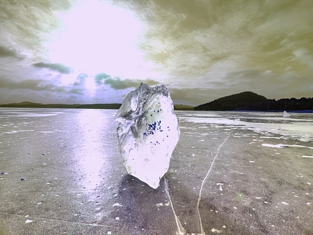 Ice covered  the lake. Big cracks in tin ice floe and reflection of Sun rays.の写真素材