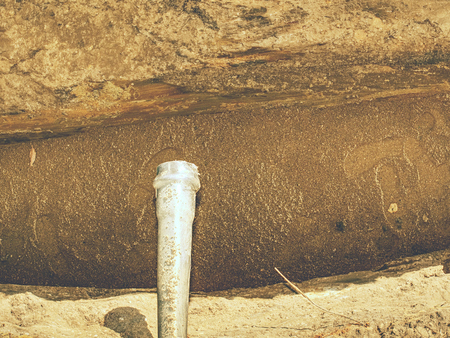 Repairing of plastic tube water delivery system. Open trench with small diameter water pipe and heap...