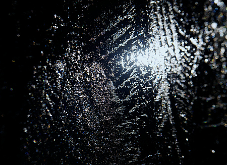 Sun rays caught in cracks in ice piece. Broken floe turn against to sharp sun.