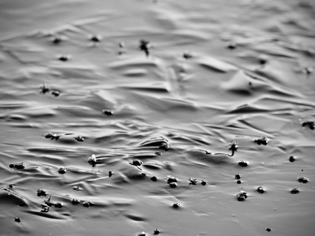 Abstract surface of frozen lake. Frozen air in arctic ice. Colorful piece of ice with sun rays...