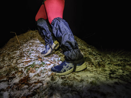 Winter night extreme runner control map.  January 25th 2019, Novy Bor, Czech Republic. Girl in forest reading map and checking a control point. Selective focusのeditorial素材