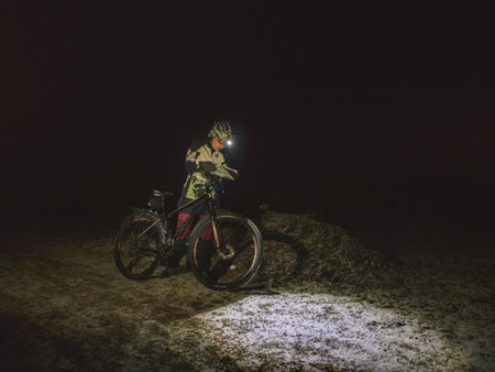 Winter night extreme bike racer control navigation and the map.  January 25th 2019, Novy Bor, Czech Republic. Outdoor orienteering check point activity. Extreme night cyclist competitionのeditorial素材