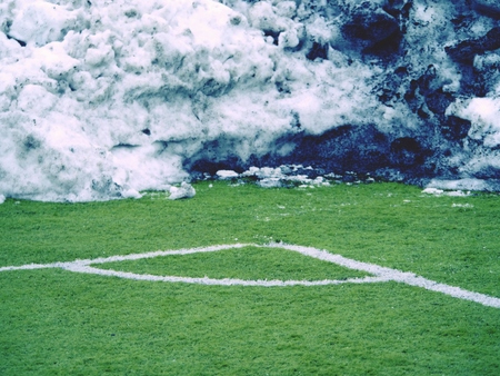 Winter football playground with snow. Winter condition training