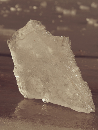 Large ice piece on freshwater ice that has broken off a glacier or an ice shelf. Reflection in ice