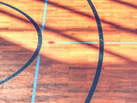 Hall floor in a gymnasium with diverse lines. Worn out wooden floor of sports hall with colorful marking lines. Schooll gym hallの写真素材