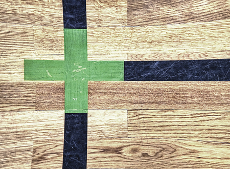 Green cross of lines. Shining renewal floor of sports gymnasium with marking linesの写真素材