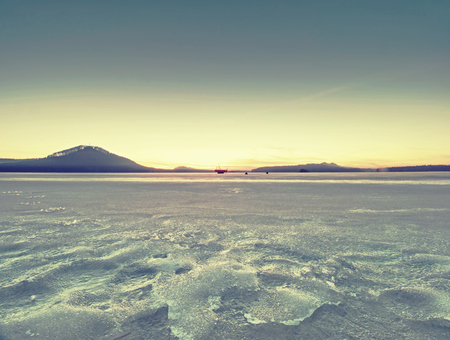 The frozen lake. Frozen lake ice captured with foot print marks. Aerial photography. Winter snow texture.の写真素材