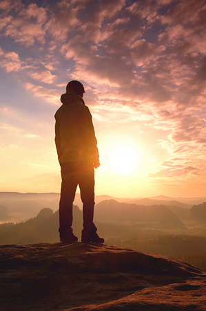 Hiker asia woman standing on ourdoor mountain trail and looking away.の写真素材