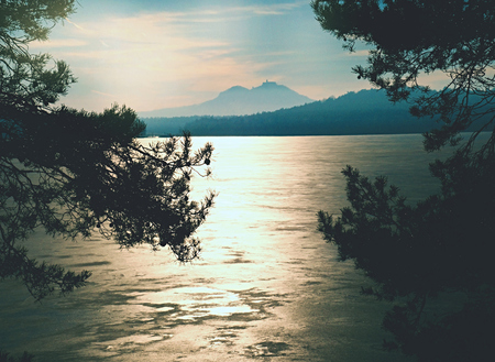 Winter ice on the lake against sunset. Colorful landscape with snowy frozen river with reflection in water. Seasonalの写真素材