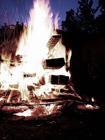 Cleaning old wooden stuff by fire. Close up of big flames fire with red and yellow flames in the...