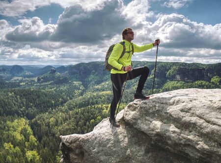 man backpacker running up on mountain top cliff edge. Travel and trail lifestyle concept adventure, outdoor summer vacationsの写真素材