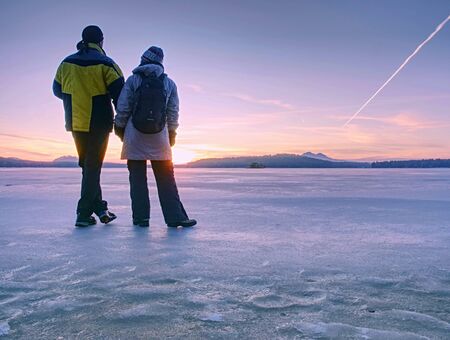 Greenland hiking travel tourist lovers with hold hands at icebergs and frozen ice floating in ocean sea. Arctic nature landscape. Adventure in the outdoors.の写真素材