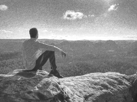 Man enjoy the view at mountain. Tourist take a break and sit on view point.  Black and white dashed pencil sketch effect.の写真素材