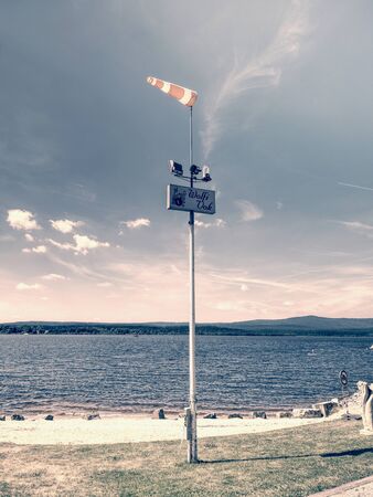 Lipno lake with small jetty, pier mole, wind sleeve. 16th of July 2019, Lipno lake Czech Republic....
