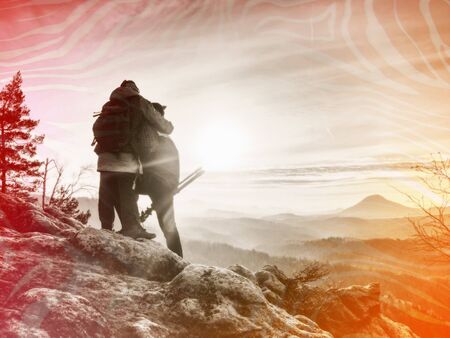 Extreme creative artist work on exposed rock edge with beautiful view into wild nature.  Abstract...