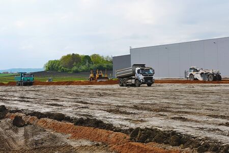 Excavators are preparing terrain for new parking place at industry building.  10th of May 2019, Plasy Czech Republic.の写真素材