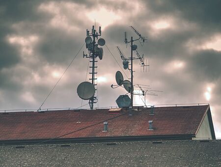 Telecommunication equipment with TV antennas, satellite dish and microwave antennasの写真素材
