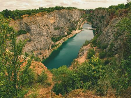 Grand canyon ov abandoned quarry of dolomite source mine. Beautiful quarry with blue water. Water reservoirの写真素材