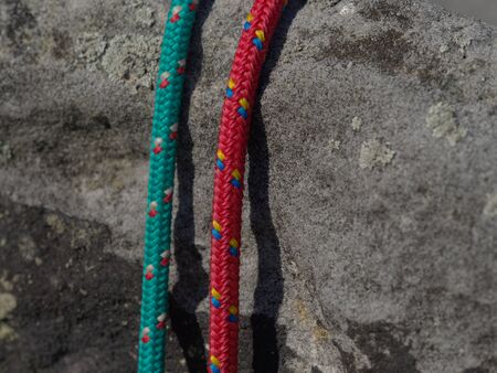Two old fashion climb nylon ropes. Detail of structure of climbers equipment on sandstone...