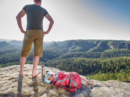 Young hiker enjoying view into landscape and prepare meal for lunch. Valley betweeon mountain forest の写真素材