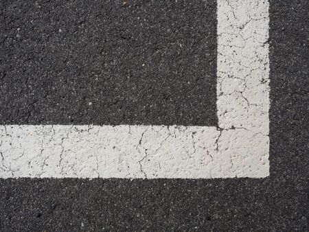 White paint line on old obsolete asphalt plaground. Empty kids areal.の写真素材