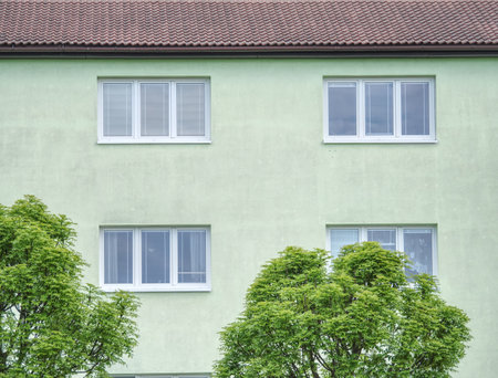 Cheap flats windows in  etage house in small town. Low cost living.の写真素材