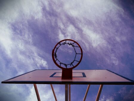 Basketball rim, basketball net on a basketball court at a basketball game. the background is clear blue sky.  Abstract filter.の写真素材