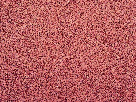 Texture of red rubber floor used for safety kids playground. Red Rubber track and background
