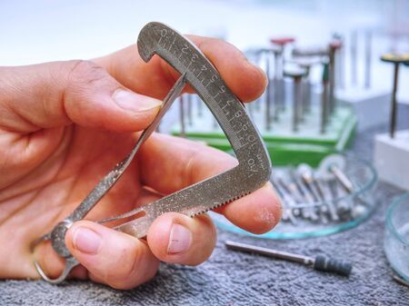 Measurement tool in dentist laboratory. Steel calibrated scale and is used for measure the size of...