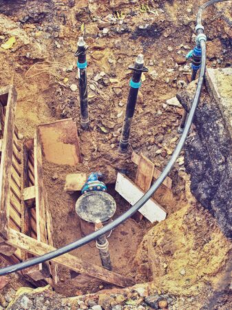 Reneval potable water system in the city. Laying plastic water pipes at the corner of a flat house