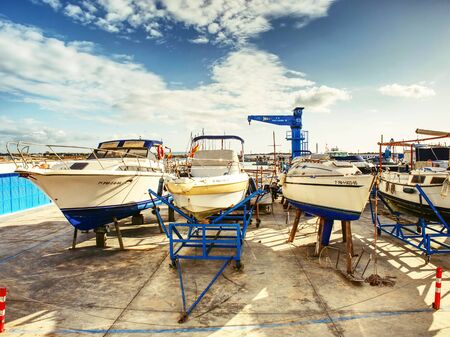 Motor boats in dry dock waiiting for regular service before sailing season. Yacht port t Palma de Mallorca city, 26thof January 2020の写真素材