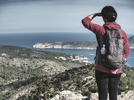 Female hiker enjoy picturesque landscape viewagainst the blue sky on the island of Mallorca, Spain.の写真素材
