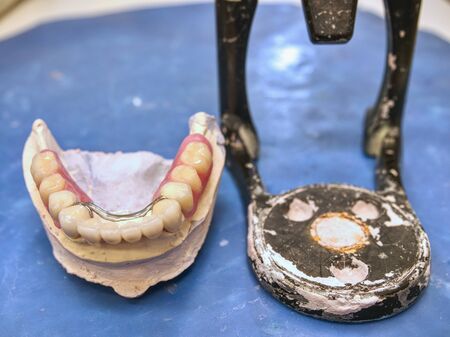 Mouth articulator and teeth. Dental technician is working on false teetの写真素材