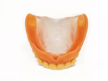 Complete upper denture. Upper semi plastic or artificial prosthesis dental for old woman.