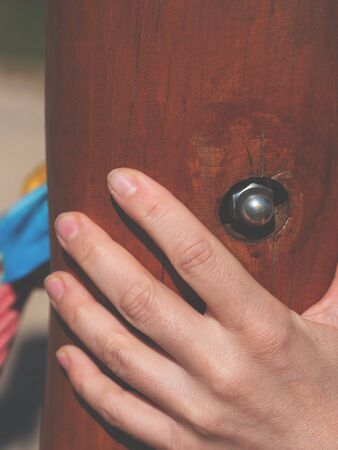 Hand hold wooden log. DIY wooden playhouse for children with slide.  Modern unusual bright wooden playground childrens lodgeの写真素材