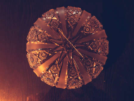 Illuminated antique ashtray. Old shiny detailed decorative glass crystal dishes and utensilsの写真素材