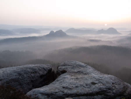 Cracked rocks of Kleiner Winterberg and foggy summer morning in the mountains.の写真素材