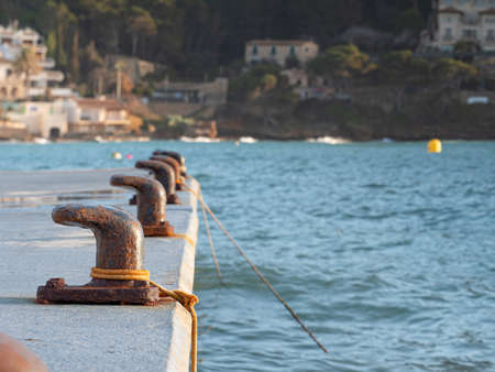Mooring pin for medium size boat. Rusty bent mooring bollard in a port.の写真素材