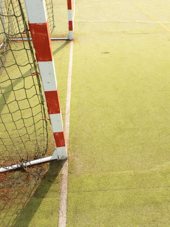 Gate for small football or handball in small stadium. Detail of gate frame. Outdoor football or handball playground, light hairy plastic carpet on groundの写真素材