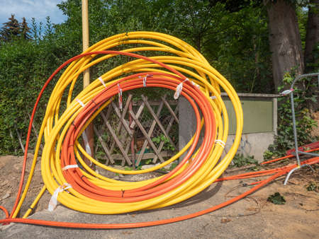 Coils of plastic casings, data cable put in underground trench. Fiber optic cable for fast internet....