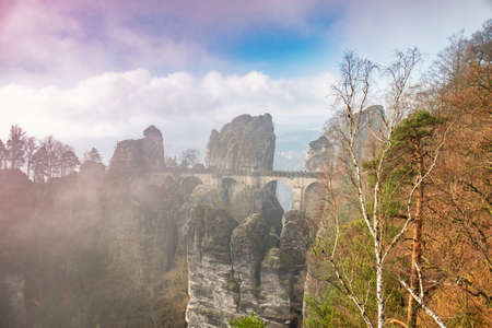 Foggy autumn sunrise at Bastei bridge. Morning in the Saxon Switzerland, Germany, view from the...