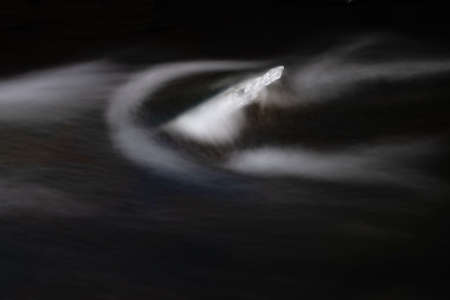 Abtract ice piece in stream. The dark edges stand out the ice conformation on rocks. Fantastic...